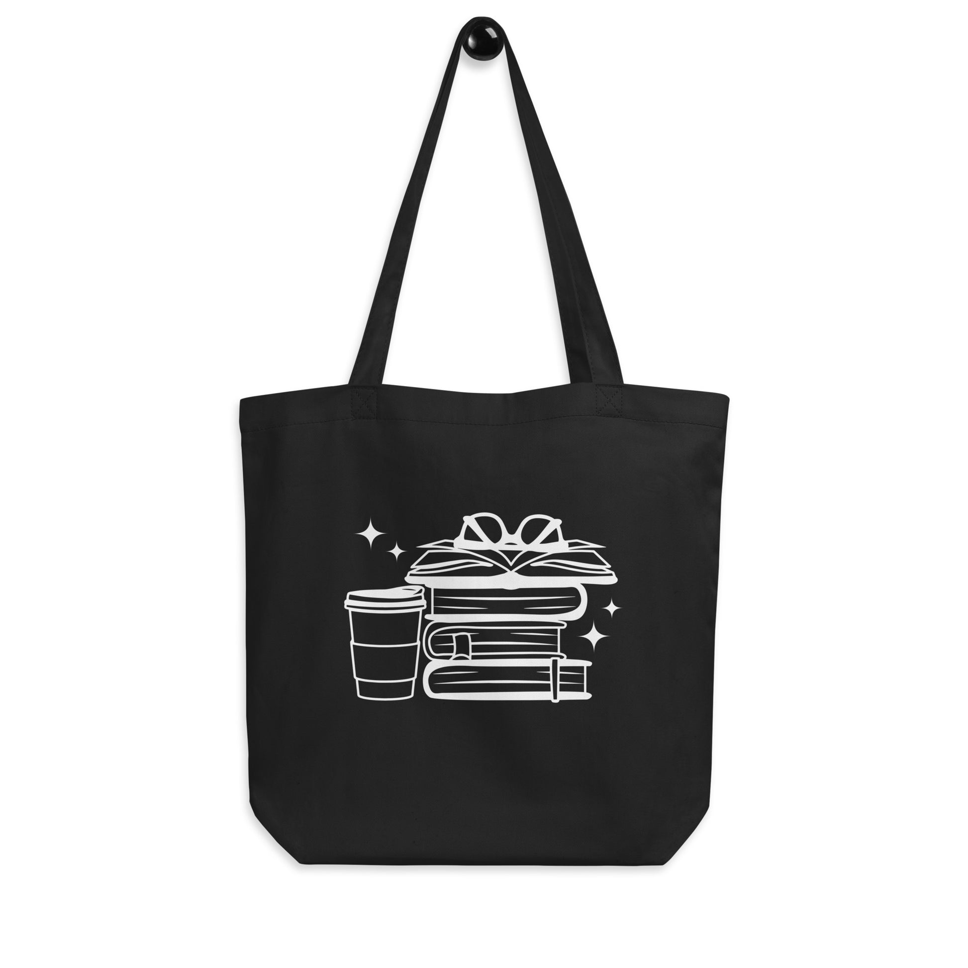 Black cotton tote bag featuring stack of books with glasses on top with coffee cup. Perfect book bag for book lovers