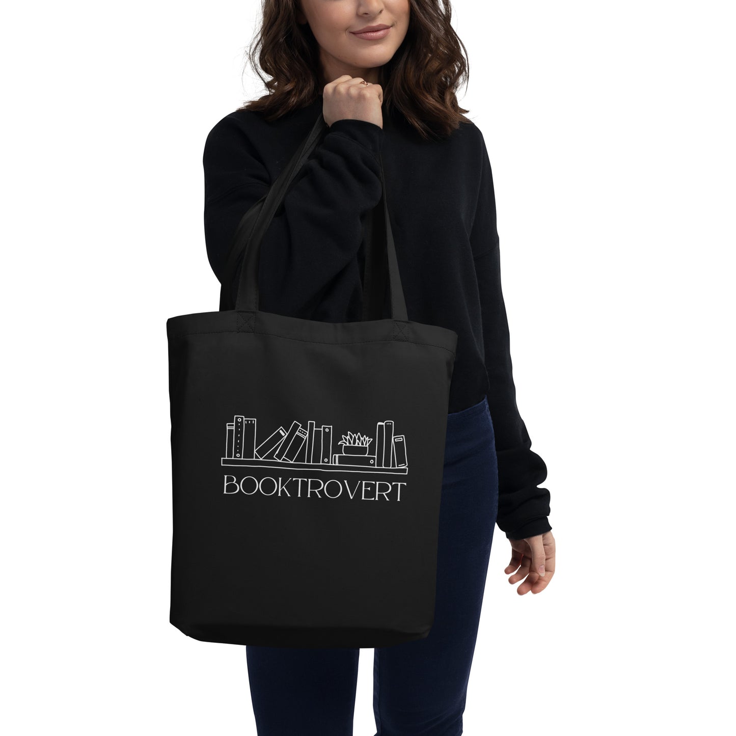 woman hold black tote that says Booktrovert