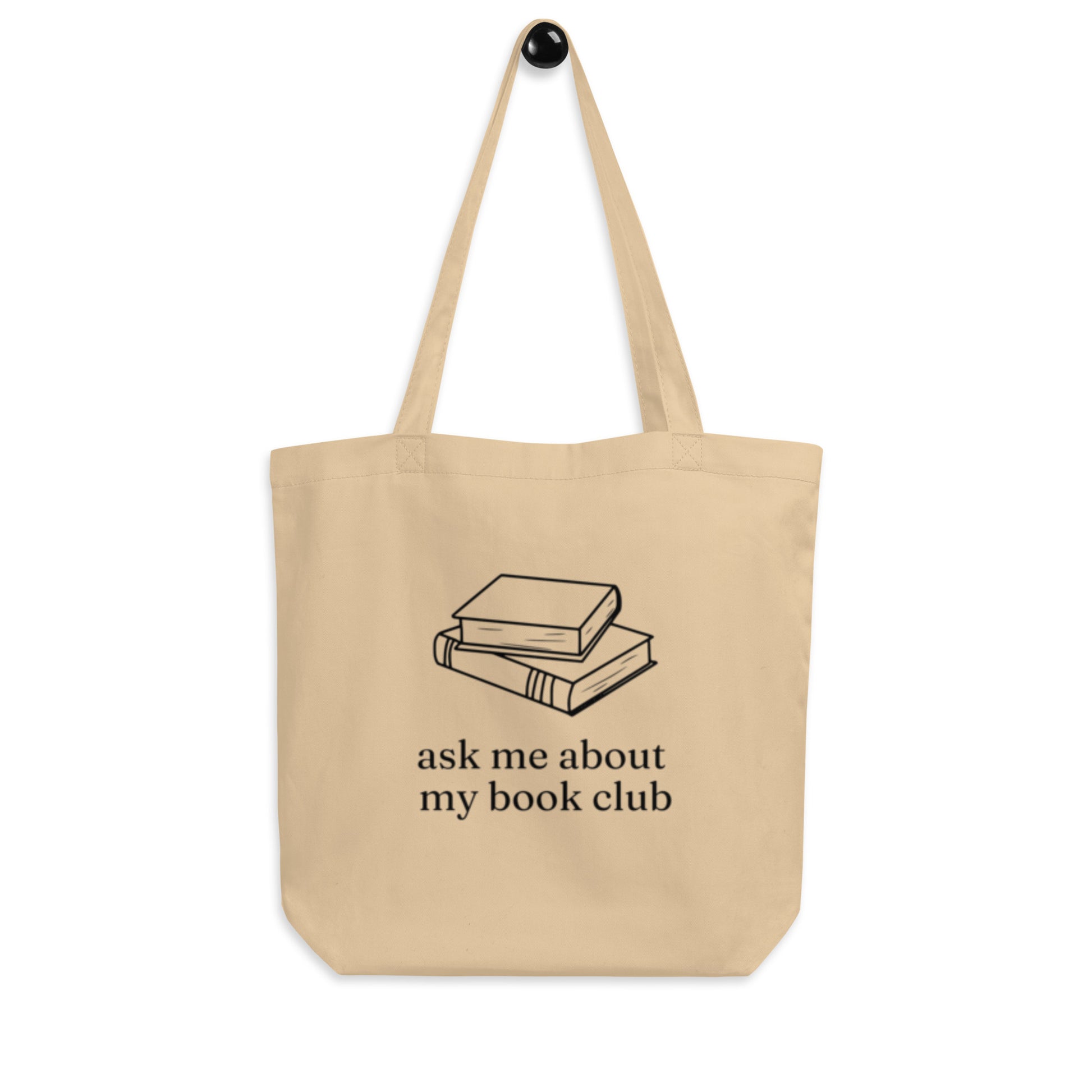 Canvas tote bag with a graphic design that has two books and says "ask me about my book club." Made from 100% eco-friendly cotton.
