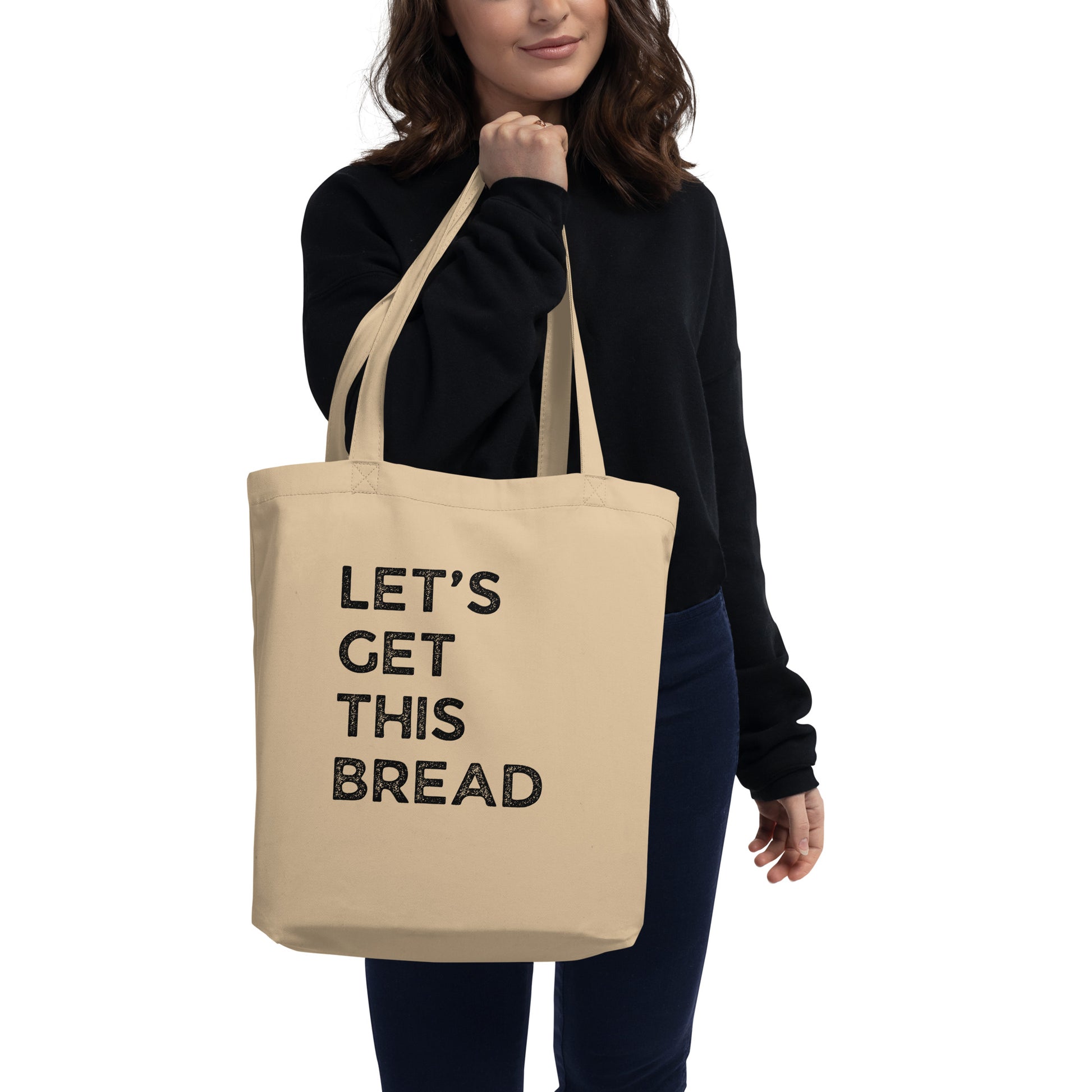 Woman holding Cotton tote bag says Let's Get This Bread